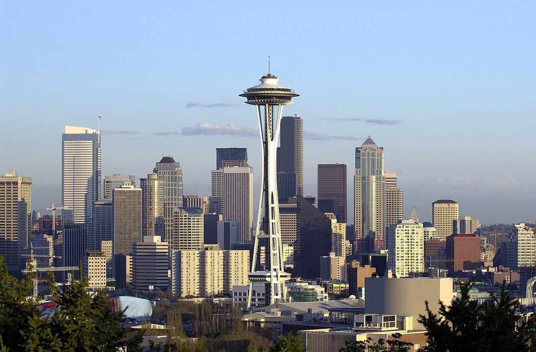The Space Needle rising above downtown Seattle's skyscrapers, seen from Kerry Park on Queen Anne hill in late-afternoon light